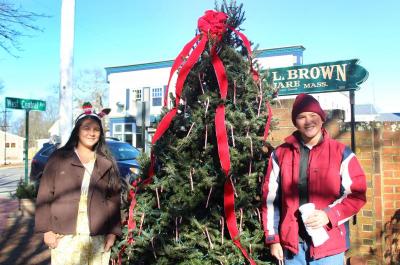 From left: Sami Fuga, 13, asked the tree for Converse sneakers and Toa Fuga, 12, asked for an XBox 360. The Fuga family just moved to Onset three months ago and wanted to get out into the community. BY ZARRIN TASNIM AHMED
