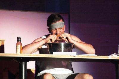 Andrew Thompson eats chicken wings during the "talent" portion of the show. Out of 25 wings, he wolfed down 10 in three minutes. BY MATTHEW BERNAT