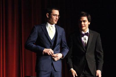 Michael Houdlette unbuttons his coat while he and Ethan DelaCruz prepare to answer some questions. BY MATTHEW BERNAT