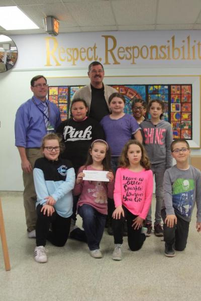 The K-Kids pose for a picture with the check they donated to Turning Point. From left, first row: Addeson Travis, Addison Dion, Hailee Ducharme, Jeffrey Poirier. Second row: Jalynn Perry, Sophia Ellis, Maddison Scott. Third row: Michael Houdlette, Pastor David Shaw and Payton Clavin. BY MATTHEW BERNAT