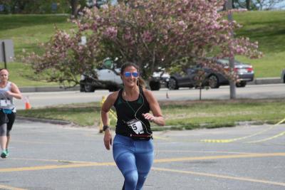 Wareham Middle School physical education teacher Nicole Stahmer smiles as spectators cheer. BY MATTHEW BERNAT