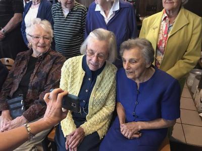 From left: Hilda Peirce, Nancy Hanaford and Claire Gordon check a photograph taken just before the group picture. Photo by: Matthew Bernat