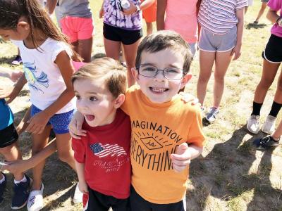 From left: Gideon Harris, 4, and Keegan Harris, 6, both of Raymond, New Hampshire, were partners during the three-legged race. Photo by: Matthew Bernat