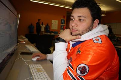 Khai Delgado uses “Competition University,” an online resource for DECA students. Photo by: Kenneth Borges.