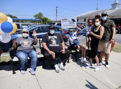 Family members waited to cheer on Bryce Fernandes in the Cap and Gown Parade. Photo by: Kenneth Borges
