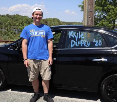 Senior Kyle Duffy poses in front of his car before the start of the parade. Photo by: Kenneth Borges