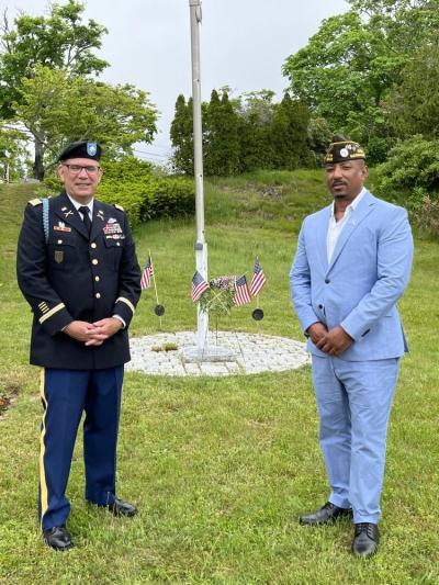 Matthew Stanton, left, and Ben Baptiste pose with a wreath laid in honor of Wareham’s fallen veterans. Photo by Claire Smith