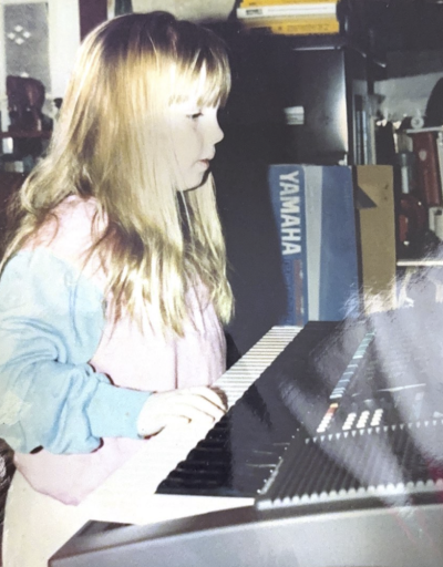 A younger Grace Morrison plays the keyboard. She began playing piano at age five. Photo courtesy: Grace Morrison