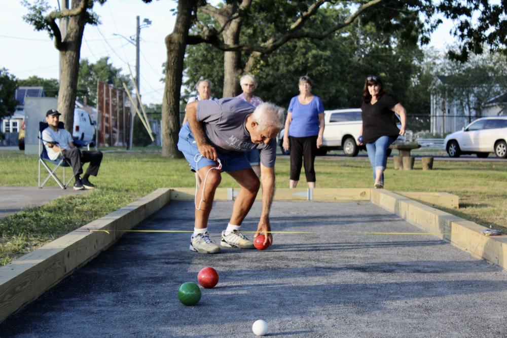 Joe Salerno teaches a group how to play bocce, an Italian lawn game. Photos by: Brooke Chandler