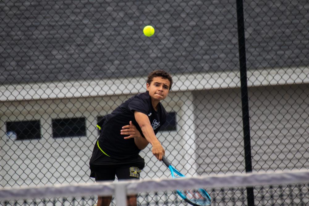 Tomas DeCanto launches a serve at his opponent. Photos by Bobby Grady