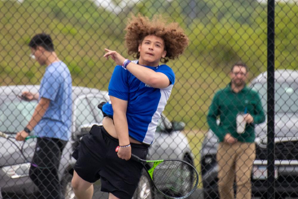 Rija Bunting serves as he wins the last high school tennis set he will ever play.