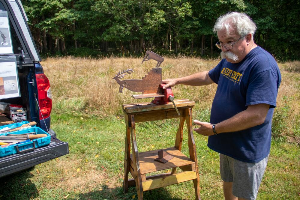 Lintala’s “studio” consists of a stool and a vice. Photo by Bobby Grady