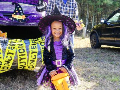 Dior Jalo, 3, stands in front of a car that matches her costume in the VFW's 2023 trunk or treat. File photo