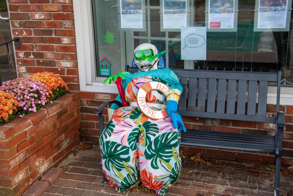 The scarecrow outside of Jack Conway Realty is less ready to scare birds and more ready for the beach. none