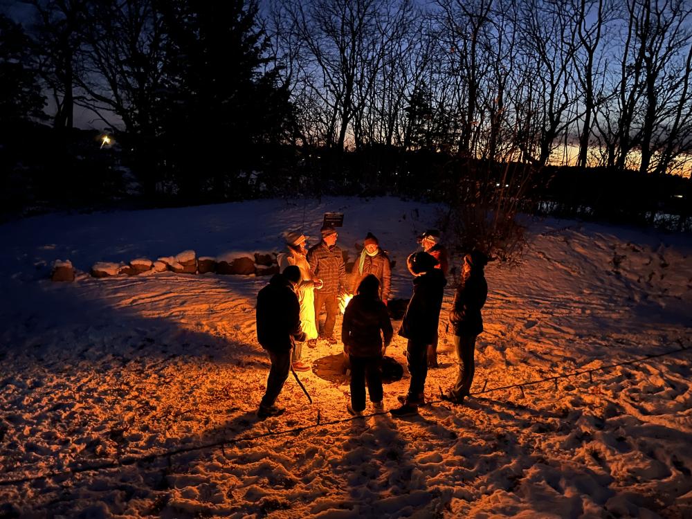 The group gathers around the fire. Photos by Brandy Muz