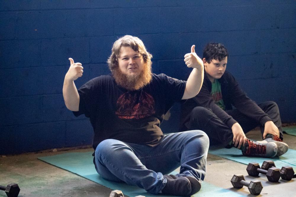 Tyler Maclver stretching before weightlifting. Photos by Brandy Muz