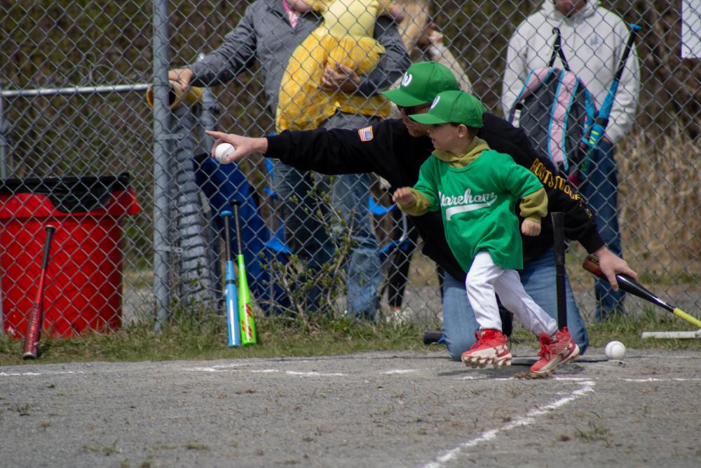 A player on the Dance Innovations VIP Teeball team bolts for first plate. Photos by Brandy Muz