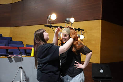 Abigail Balano, left, puts a wig on Lilyan Medina, who plays Cady Heron. Photos by Nick Mossman