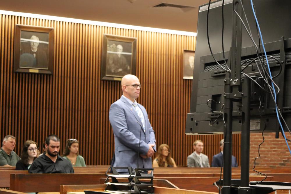 Selectman Jared Chadwick stands in a courtroom on Thursday, July 9, before separate charges from earlier this year were dismissed. Photo by Nick Mossman