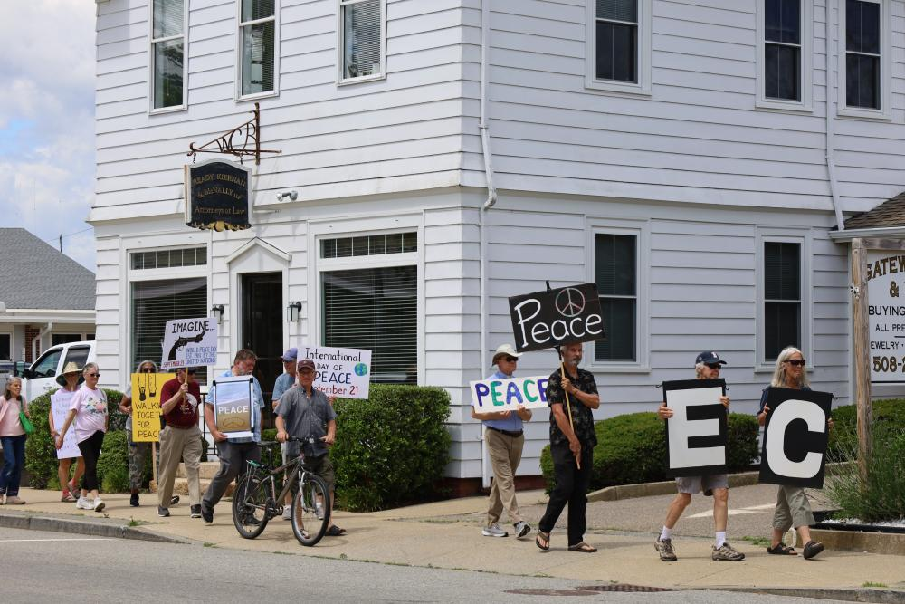 Wareham Faith in Action members hold signs during a June peace walk along Main St. File photo