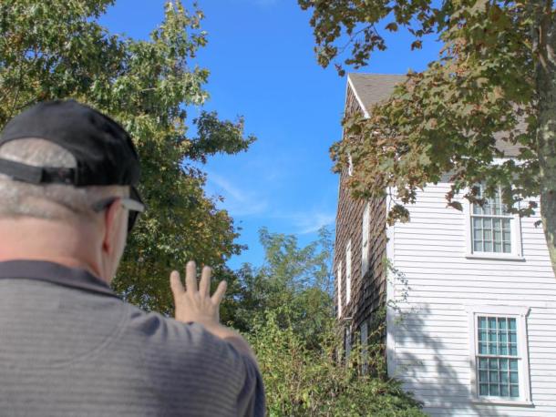 Carlston Wood stands outside of the famously haunted Fearing Tavern. Photo by Brandy Muz