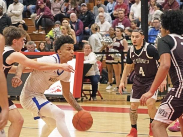 Team captain Aaron Cote dribbles down the court at the Monday final four game. File photo 