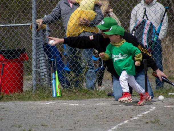 A player on the Dance Innovations VIP Teeball team bolts for first plate. Photos by Brandy Muz