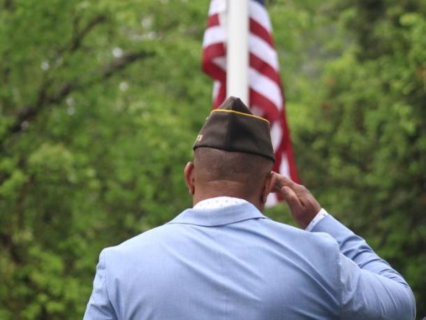 Onset VFW Post commander Benjamin Baptise salutes the flag.