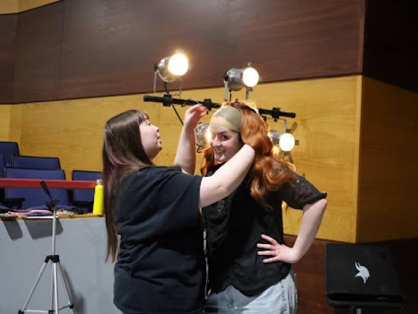 Abigail Balano, left, puts a wig on Lilyan Medina, who plays Cady Heron. Photos by Nick Mossman