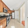 View along the kitchen toward the hardwood-floored living area in the 2 bedroom apartment at 17 Beeden Road, Westport