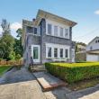 Front of 370 Maple Street, a cedar-shingled two-family home with trimmed hedges across from Buttonwood Park, New Bedford
