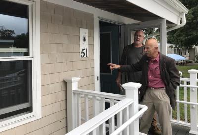 Wareham Housing Authority Chair Bob Powalitas stands at the entrance of the new affordable housing unit at Agawam Village. Photo by: Matthew Bernat