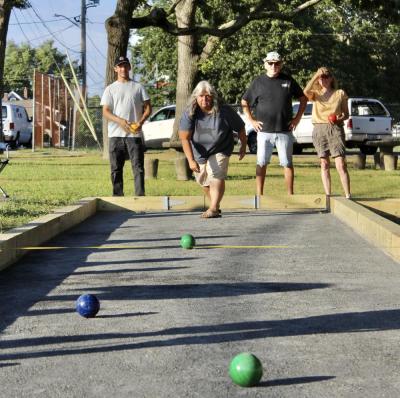 Participants roll bocce balls to get them close to the pallina.
