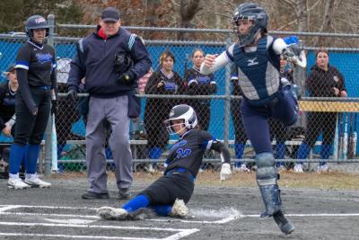 A runner slides into home.