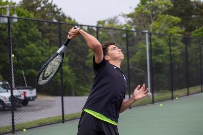 Chase Card winds up for a serve.