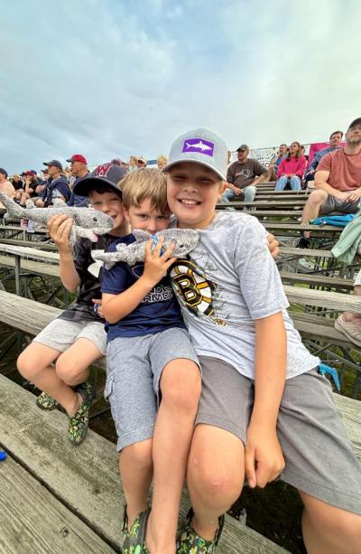 10-year-old Tommy Flynn left, Hunter Flynn, 5, and Mason Flynn 7 pose with their sharks.