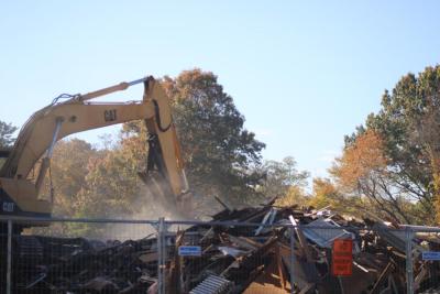 Dust settles as the home is leveled. Photo by Brandy Muz