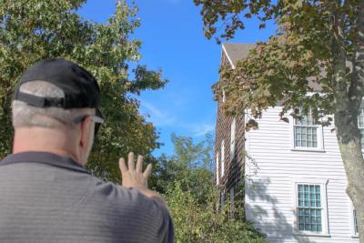 Carlston Wood stands outside of the famously haunted Fearing Tavern. Photo by Brandy Muz