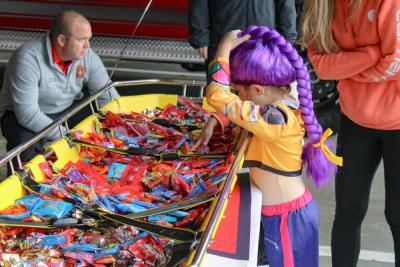 Rumi from Kpop Demon Hunters gets candy from a stretcher at the fire department.