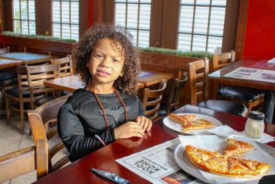 Taking a break from saving the city, Tristan McLean grabs a slice after trick-or-treating. 