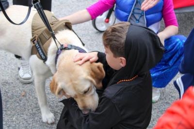 Lexi the comfort dogs gives some kisses instead of candy.