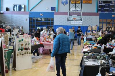 The gym packed with booths and tables.