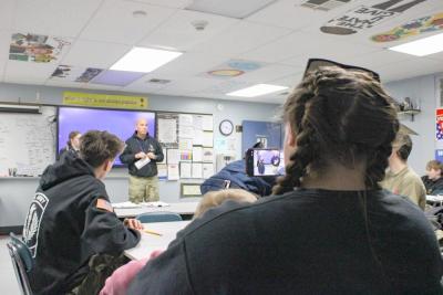 Ava's mother Jenna snaps photos of the ceremony.