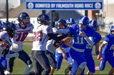 The Upper Cape Tech offense pushes past the defensive line. 