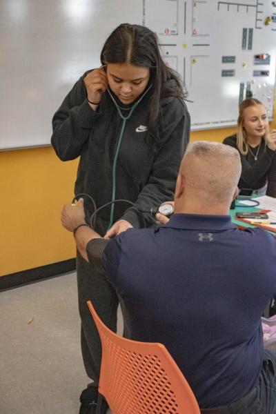 Alivia Benitez-Gaudette takes Pina's blood pressure.