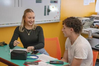 Gloria Jorjakis and Frederic Roy take notes.