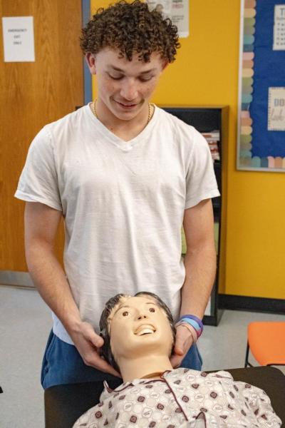 Frederic Roy makes sure the dummy's airway is clear.