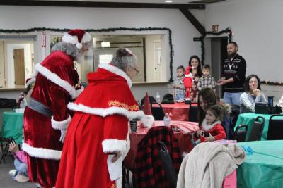 Santa and Mrs. Claus greet a baby.