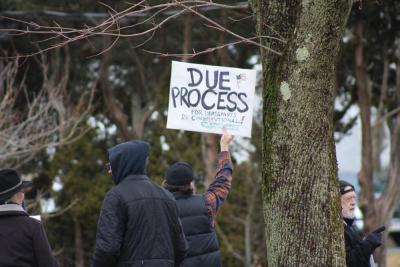 Sean McMills waves to passing cars honking in support. Photos by Brandy Muz