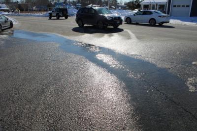 Water trickling onto Onset Avenue. 